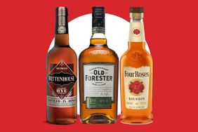 Three whiskey bottles Rittenhouse Rye Old Forester Rye and Four Roses Bourbon displayed against a red and white background