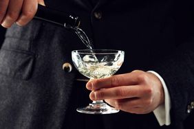 Person pouring champagne into a glass