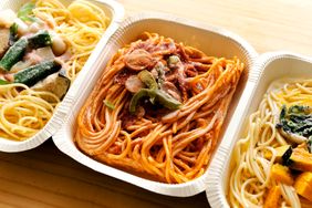 Three frozen meal trays with pasta dishes displayed