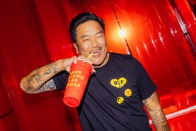 Roy Choi holding a drink with a playful expression