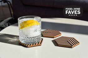 Three coasters with a glass of soda on a coffee table