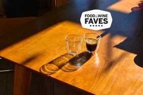 De'Longhi Double Wall Thermal Espresso Cups on a wood table in the sunlight