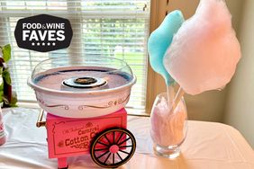 Pink and blue cotton candy cones next to the Nostalgia Cotton Candy Machine
