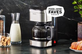 Krups simply brew coffee maker on black granite counter with breakfast foods