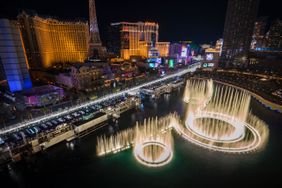 Bellagio fountains at night with Las Vegas Strip hotels in the background