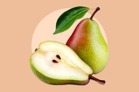 A whole pear and a halved pear displayed with a leaf