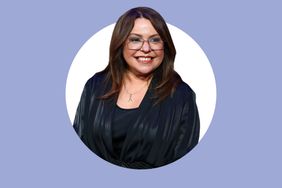 Rachael Ray smiling standing against a purple background