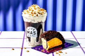 A dessert taco and a whippedcream topped drink with granola displayed on a tiled surface