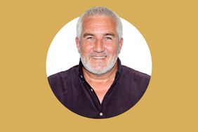 Paul Hollywood smiling in front of a solid background