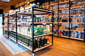 Shelves in a grocery store with a variety of snacks and food products displayed