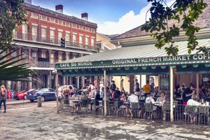 People gather in front of the historic Cafe Du Monde market in the French quarter of New Orleans Louisiana USA.